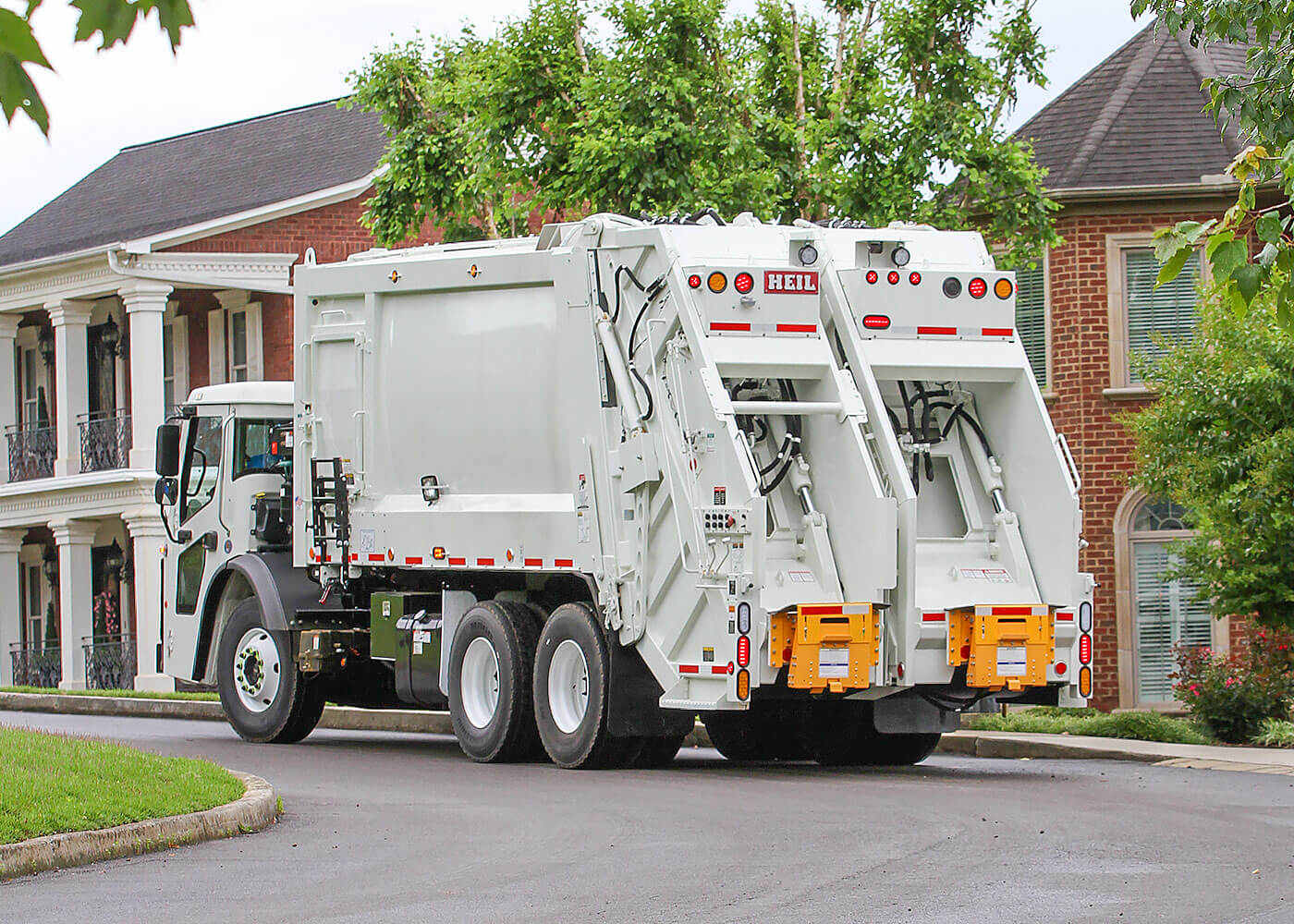 Garbage trucks with two compartments for recycling and trash pickup