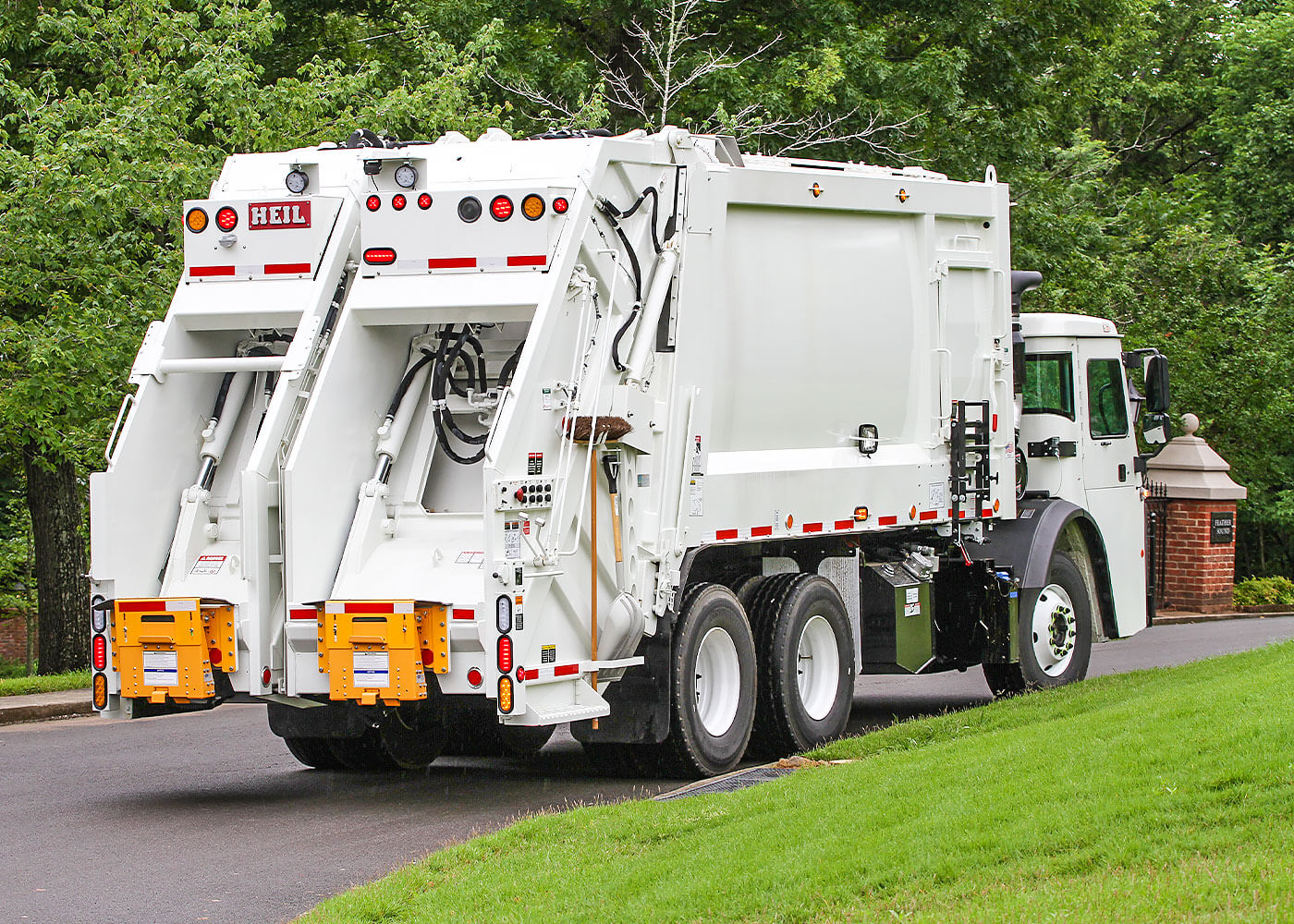 Heil split body rear loader garbage trucks with two hopper compartments