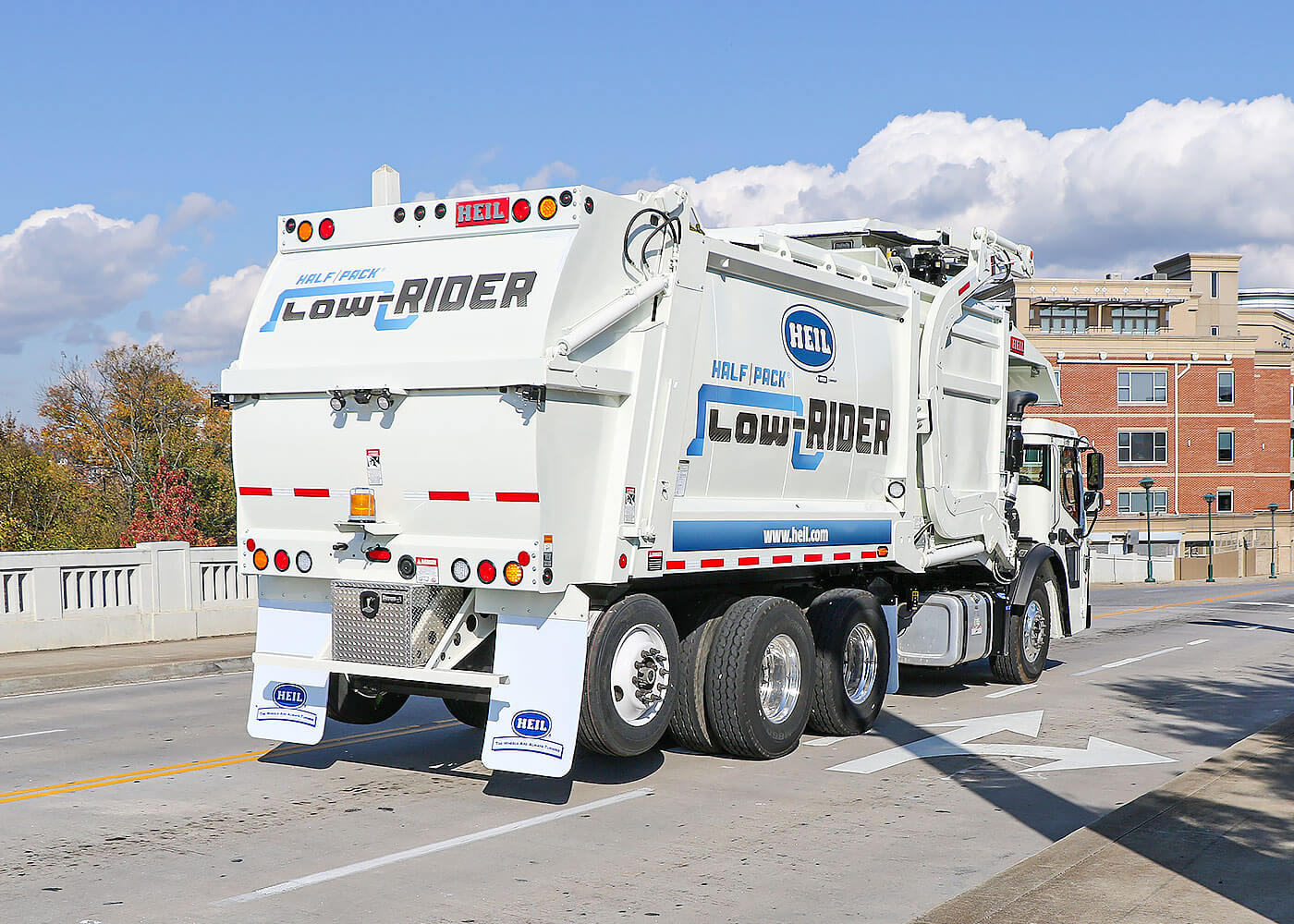 Lowrider front load refuse trucks have low height and less weight for automated collection