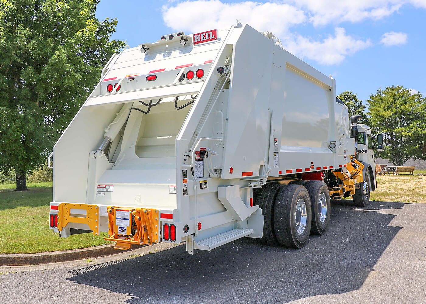 Multipack side load trash trucks with rear load body