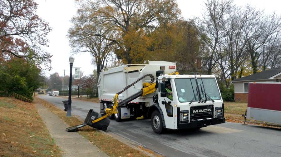 Sideloader Garbage Truck Picks Up Knocked over Refuse Carts Containers